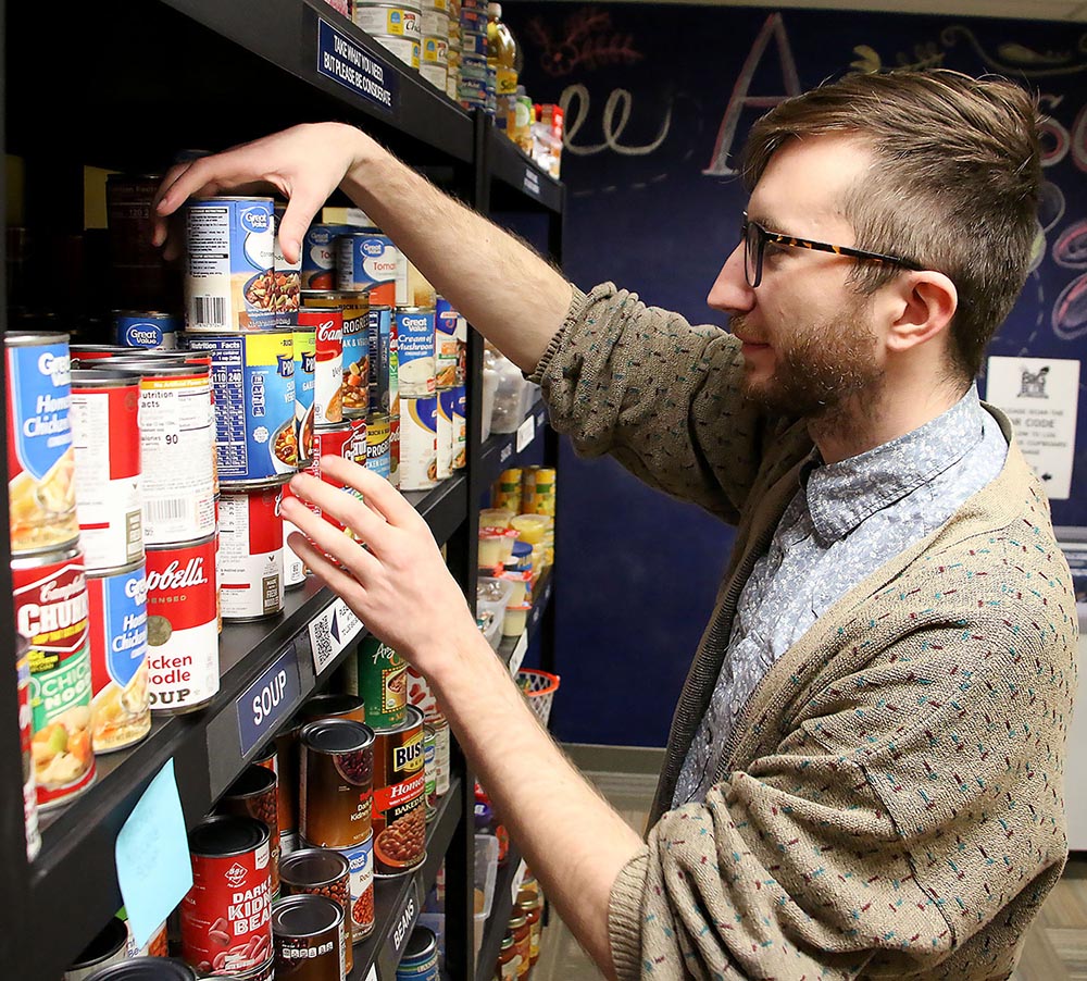 UNK food pantry worker stocking shelves