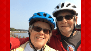 Warren and his wife take a selfie with bike helmets on.
