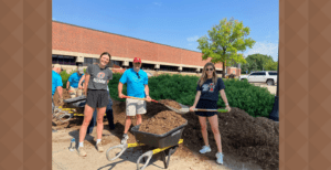 University of Nebraska Foundation employees Claire Rush, David Belieu and Abby Dieter plant flowers at the University of Nebraska at Omaha during Day of Service on June 2.