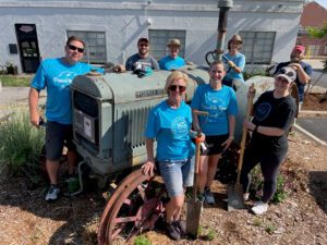 Team members from the University of Nebraska Foundation planted flowers and cleaned up the Lester Larsen F. Tractor Museum in preparation for the organization’s upcoming anniversary celebration.