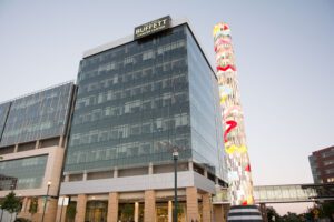 The glowing, colorful Search Tower at the Fred and Pamela Buffett Cancer Center