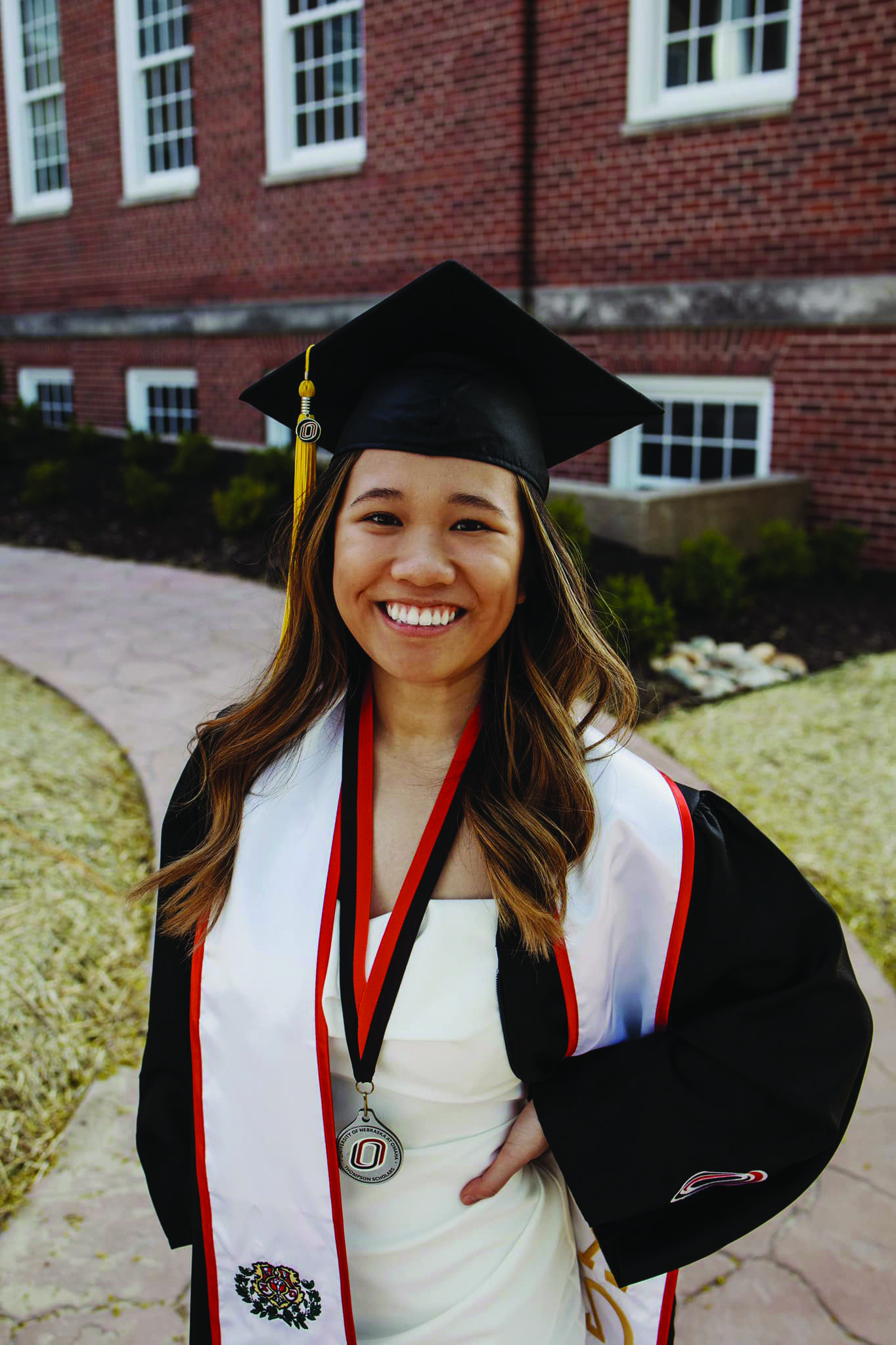 Uyen Tran poses in her graduation cap and gown.